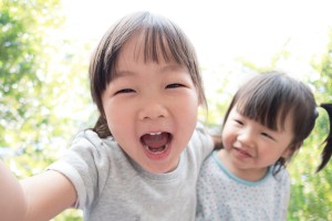 Happy child take a selfie in the park asian